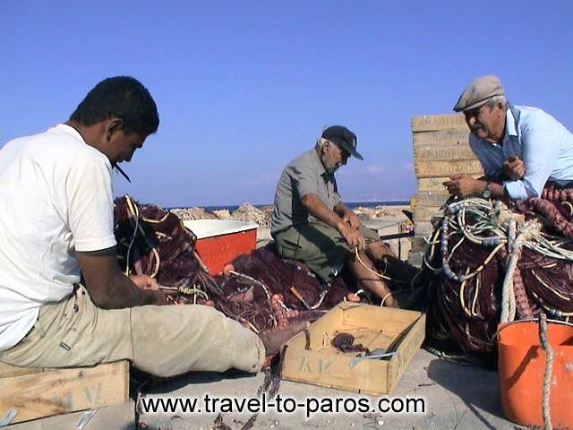 FISHERMEN IN AMPELAS BEACH - The fishermen in the small harbour of Ampelas, while they are prepared...