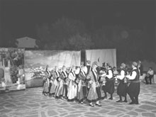 Youngsters on the Cycladic island of Paros have hundreds of bars and cafeterias to frequent and wile away their summer holidays but many have decided to take up traditional folk dancing instead. <br><br>

Visitors to the island this summer were dazzled by the performances of the local Naoussa Paros music and dance group, which is due to put on its biggest show of all next year. <br><br>

The number of young people taking part in the performances suggests that many teenagers are looking for deeper, long-lasting enjoyment than the ephemeral pleasure of frequenting bars and nightclubs, even if it means wearing heavy traditional costumes on warm summer nights. <br><br>

The group has been putting on traditional dance performances since 1988. It was founded in the town of Naoussa by two teachers at the local school, Ipapandi Roussou and Lefteris Menegos. People of all ages from all over the island can join, and folk dancing soon becomes a way of life for members of the group. One young man, who left the island and is now working in Brussels, makes a point of dancing with the group whenever he is back visiting family and friends. <br><br>

Schoolchildren, university students and adults dance in authentic costumes as well as those that have been painstakingly copied from original designs and sewn with great pride by local volunteers. The costume production is very costly. Fabrics and other necessary materials are purchased in Athens and brought over to the island. <br><br>

The Roussos family has set up a museum in the central square of Naoussa of authentic Greek costumes that they have collected over the years. Donors have also come forward and the collection is growing steadily. <br><br>

The dancing is accompanied by live music played by musicians on traditional Greek instruments, including laouto (lute), toumbeleki (snare drum) and tsambouna (a type of bagpipe typical of the islands). The songs, too, are sung by members of the group. <br><br>

Apart from regional dances - they have over 100 in their repertoire from all over Greece and Asia Minor - the performances include little sketches portraying local customs, for example a typical Paros wedding. Practice takes place after school and work hours and performances are put on year-round. <br><br>

On August 23 every year in Naoussa Bay, the group participates in the reenactment of the raid on Paros by Barbarossa and his pirates in the 16th century. Young men dressed as pirates try to land from fishing boats but are resisted by the locals. <br><br>

The pirates demand to see the young women dance so they can pick the ones they like and carry them off. While the dancing is going on, the locals ambush the pirates and push them back into their boats. Finally, they are forced to leave and the beautiful young girls are spared. <br><br>

The group’s income is from the sales of tickets for the performances as well as music and books, which include a collection of recipes from Paros in Greek and English. Donations from sponsors are also welcome. <br><br>

The group usually travels abroad once a year to cities where folk-dancing competitions and festivals take place. In July this year they represented Greece at a Polish festival held on the outskirts of Warsaw. They have also represented Greece at events in several other countries, and also won a number of prizes. <br><br>

For the young people who travel abroad with the group, it is an opportunity to get to know the people of the countries they visit, their customs and cultures. They are hosted by local families and are taken out on trips and sightseeing tours. <br><br>

The performances of the Naoussa Paros group are spectacles of the highest quality that should not be missed. It is clear from their shows that much love and hard work goes into the preparation of each performance. Each one is steeped in history, tradition, rhythm and music. It is all great fun, for the audience, too. <br><br>

Source: <a href=http://www.ekathimerini.com/4dcgi/news/civ_&xml/&aspKath/civ.asp?fdate=18/08/2006 target=_blank>e-Kathimerini</a>